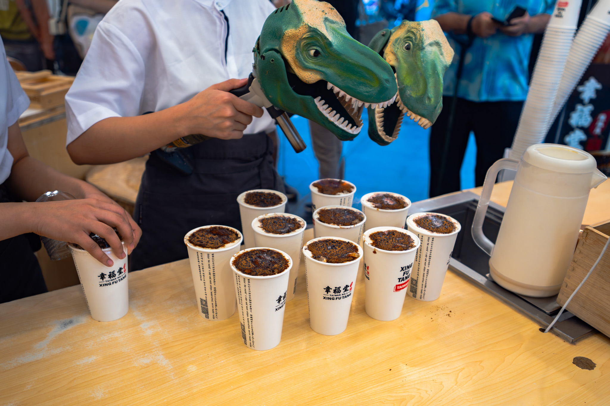 Xing Fu Tang staff roasting boba tea tops with dinosaur torches